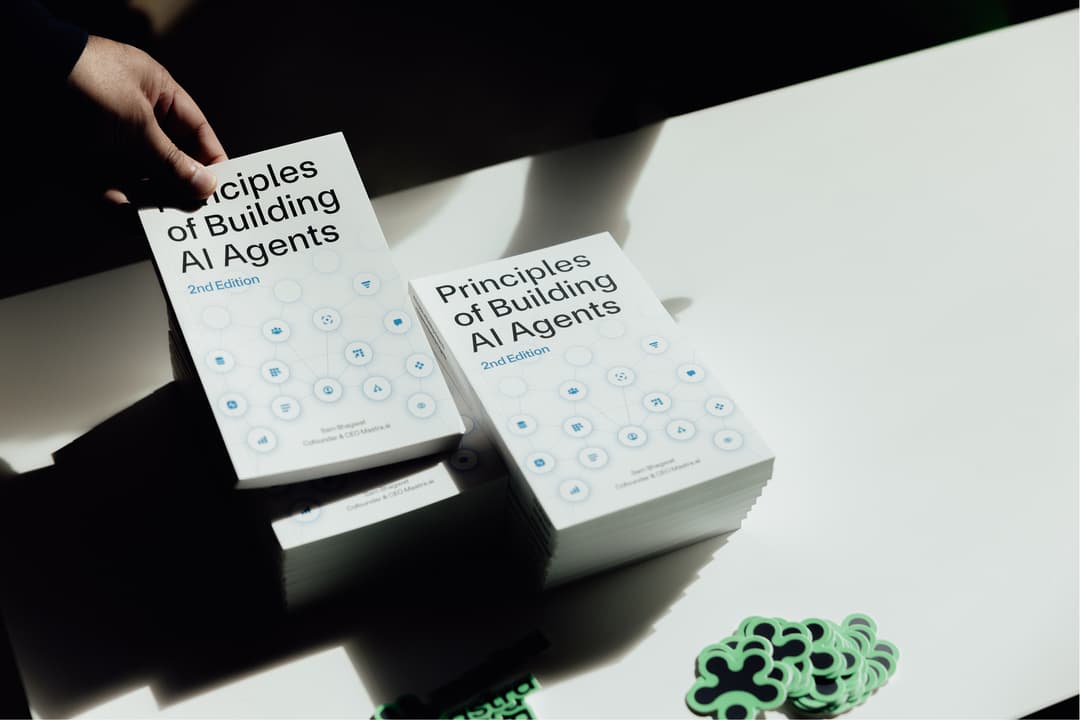 Principles of Building AI Agents displayed on an event.