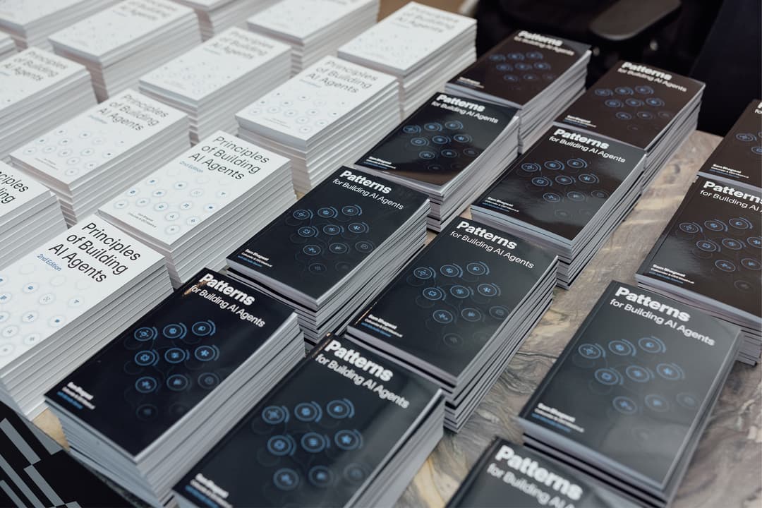Patterns of Building AI Agents stacked on a shelf.